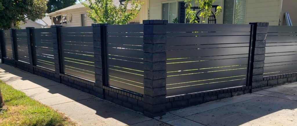 Monument Color Horizontal between masonry pillars with 6 inch and 2.5 inch slats with .5 inch spacers